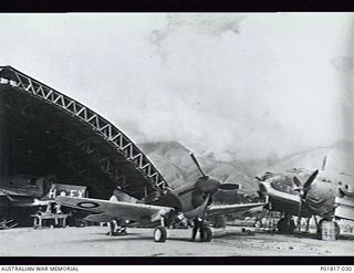 Goodenough Island, D'Entrecasteaux Islands, Papua, 1944-03-07. RAAF aircraft undergoing repairs at the large repair hangar operated by No. 26 Repair and Salvage Unit RAAF. The aircraft in the ..