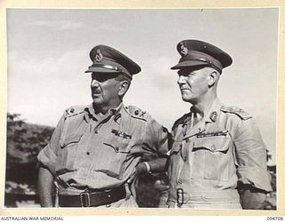 LAE AREA, NEW GUINEA. 1945-08-04. LIEUTENANT GENERAL B.M. MORRIS, GENERAL OFFICER COMMANDING ANGAU (1) AND MAJOR GENERAL V.A.H. STURDEE, GOC FIRST ARMY (2), ATTENDING THE ARTS AND CRAFTS EXHIBITION ..