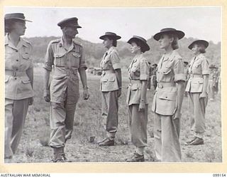 LAE, NEW GUINEA, 1945-12-01. COLONEL G.H.S. MORAN INSPECTING AWAS PERSONNEL ATTACHED TO 2/1 BASE WORKSHOP, CORPS OF AUSTRALIAN ELECTRICAL AND MECHANICAL ENGINEERS, ON THE OCCASION OF THE THIRD ..