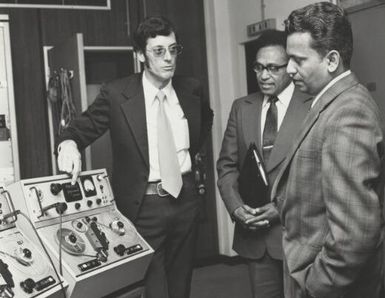 John Manikiam with Rod Christopher, radio producer and Paul Sotutu counsellor for Fiji High Commission discussing radio equipment at the AIS head office in Canberra, 1975 / John Crowther