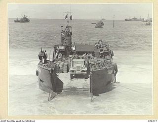 AITAPE, NEW GUINEA. 1945-01-08. AN AMERICAN LST (LANDING SHIP, TANK) DISCHARGING A LOAD OF AMMUNITION FOR THE 6TH DIVISION