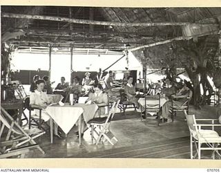 SEVENTEEN MILE, PORT MORESBY, PAPUA, NEW GUINEA, 1944-03-01. THE SISTERS' MESS AT THE 2/9TH GENERAL HOSPITAL HAS ALL RECREATIONAL FACILITIES. NURSES ARE PICTURED BEING ENTERTAINED IN THE MESS BY ..