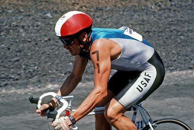 Major (MAJ) Gary Castelli, a member of the US Air Force, takes part in the bicycle race, part of the 1987 Ironman Competition