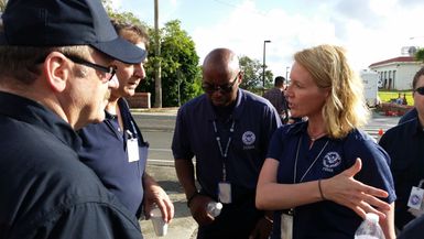 Guam, May 17, 2015 - The Typhoon Dolphin FEMA Leadership team discusses how best to Support Guam and CMNI in assessing damages from Typhoon Dolphin. From left: Region 9 IMAT leader Kevin Cavanaugh, Region 9 Deputy IMAT leader Mark Armstrong, FEMA official Willie Nunn, and National IMAT leader Deanne Criswell.