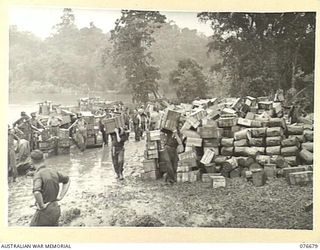 JACQUINOT BAY, NEW BRITAIN. 1944-11-04. PERSONNEL OF THE 6TH INFANTRY BRIGADE UNLOADING LANDING BARGES AT THE UNIT BRIDGEHEAD