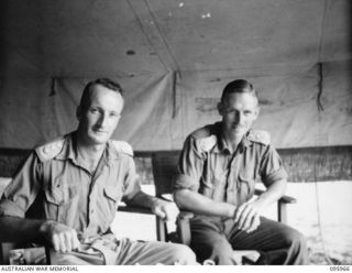 CAPE WOM, WEWAK AREA, NEW GUINEA. 1945-08-31. CAPTAIN D.M. MACREA, LIAISON OFFICER (LEFT) AND CAPTAIN A.C. PEPPER, G3(O), (RIGHT), STAFF OFFICERS, HEADQUARTERS ROYAL AUSTRALIAN ENGINEERS 6 DIVISION