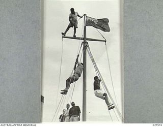 CLIFTON GARDENS, SYDNEY, AUSTRALIA. 1942-12. NATIVES FROM THE PACIFIC ISLANDS SERVING WITH 1 AUSTRALIAN WATER TRANSPORT GROUP PRACTICE SCALING THE RIGGING