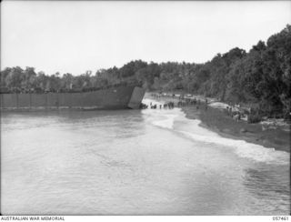 Finschhafen, New Guinea. 1943-09-22. Allied troops of the Finschhafen Force disembarking on to the assault beach from a Landing Craft Tank