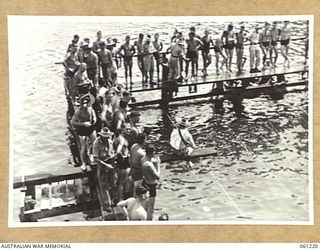 PORT MORESBY, NEW GUINEA. 1943-11-28. COMPETITORS WAITING FOR THE START OF THEIR RACES AT THE ALLIED SERVICES GRAND SWIMMING CARNIVAL