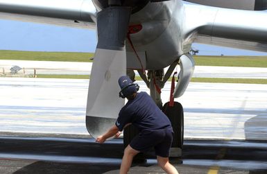 Royal Australian Air Force (RAAF) Leading Aircraftman Pasaricek Dalibor, 10th Squadron, RAAF Edinburgh, Australia, turns the props on the RAAF AP-3C Orion aircraft used for long distance surveillance and interdiction missions as it sits on the flightline at Andersen Air Force Base (AFB), Guam. The aircraft and crew are on station to participate in the joint exercise TANDEM THRUST 03, a joint US, Canada, and Australia exercise conducted in the Marianas islands to include Guam and Tinian