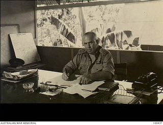 Port Moresby, New Guinea. 1944-05-09. Brigadier W. C. D. Veale MC DCM , Commanding Moresby Base Sub area, sitting working at his desk
