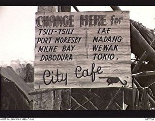 NADZAB AIRSTRIP, NEW GUINEA. 1943-09-18. HUMOROUS SIGN ERECTED AT THE CONTROL TOWER OF NO. 1 AIRSTRIP