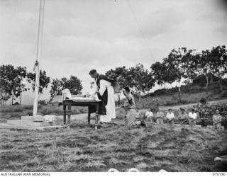 PORT MORESBY, NEW GUINEA. 1944-02-07. WX17091 CHAPLAIN C.W. CUNNINGHAM, MBE., (ROMAN CATHOLIC) (1) AT THE CONSECRATION DURING REQUIEM MASS AT BOMANA WAR CEMETERY WITH NX45303 PRIVATE J.A. SMITH (2) ..