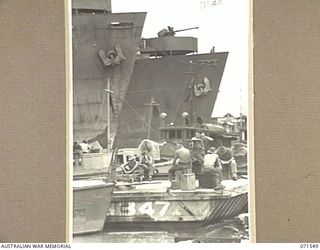 LAE, NEW GUINEA. 1944-03-23. UNITED STATES LIBERTY SHIPS BEING UNLOADED BY THE DOCKS CONTROL UNIT AT HEADQUARTERS LAE BASE SUB-AREA