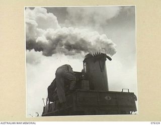 LAE, NEW GUINEA. 1944-09-27. PERSONNEL OF A UNITED STATES ARMY CHEMICAL WARFARE UNIT TESTING A PORTABLE SMOKE SCREEN TRUCK IN CO OPERATION WITH THE 43RD FIELD ORDNANCE DEPOT