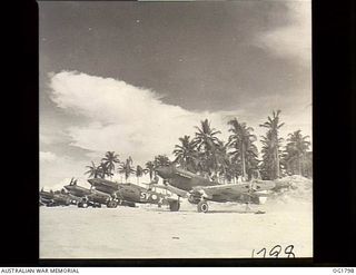 MOMOTE, LOS NEGROS ISLAND, ADMIRALTY ISLANDS. C. 1944-04. KITTYHAWK AIRCRAFT OF NO. 76 (KITTYHAWK) SQUADRON RAAF WARM UP ON THE LINE AS THEY WAIT TO TAKE OFF. THEY WILL TAXI FROM REVETMENT AREA TO ..