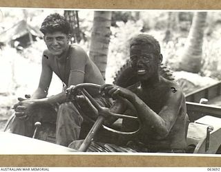 HUON PENINSULA, NEW GUINEA. 1944-01-14. 31096869 CORPORAL L. L. KANELOS (1) AND 11044080 PRIVATE FIRST CLASS L. L. HIGGINS (2) MEMBERS OF THE 5TH UNITED STATES AIR SUPPORT CONTROL SQUADRON, ..