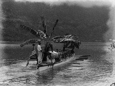 [Pacific Island men in a canoe]