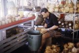 French Polynesia, man processing coconuts in Papeete