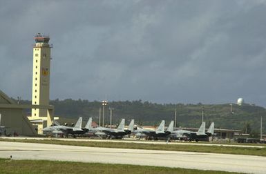 A row of F-15 Eagles assigned to the Japan Air Self Defense Force (JASDF) at 8th Air Wing (AW) from Tsuiki Air Base, Japan, sit on the runway at Andersen Air Force Base (AFB), Guam, in support of Exercise COPE NORTH 2002