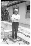 Man standing outside house