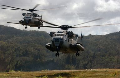 US Marine Corps (USMC) CH-53D Sea Stallion helicopters, Marine Heavy Helicopter Squadron 363 (HMH-363), Red Lions, Kaneohe Bay, Hawaii (HI), approach a landing zone to insert a 3rd Marine Regiment (MAR REGT) rescue force during a Tactical Recovery of Aircraft and Personnel event in support of Exercise RIM OF THE PACIFIC (RIMPAC) 2004. RIMPAC is the largest international maritime exercise in the waters around the Hawaiian Islands. This year's exercise includes seven participating nations; Australia, Canada, Chile, Japan, South Korea, the United Kingdom and the United States. RIMPAC is intended to enhance the tactical proficiency of participating units in a wide array of combined...