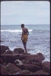 Kairiru: woman on rocky coastline