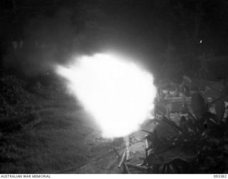 BARGES HILL, CENTRAL BOUGAINVILLE, 1945-06-26. A TROOP, 10 BATTERY, 4 FIELD REGIMENT, IS CONTINUOUSLY HARASSING THE JAPANESE WITH FIRE AND GIVING THEM NO REST DAY OR NIGHT. SHOWN, LAYING HARASSING ..