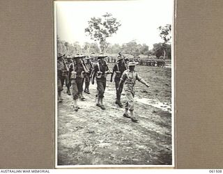 POM POM VALLEY, NEW GUINEA. 1943-11-30. 2/12TH AUSTRALIAN INFANTRY BATTALION, ADVANCING IN "COLUMN OF ROUTE" AS THEY MARCH OFF THE SPORTSGROUND. IDENTIFIED PERSONNEL ARE: CORPORAL S. POLANDS (3); ..