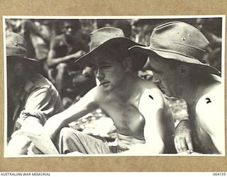 MOUNT PROTHERO AREA, NEW GUINEA. 1944-01-2O. VX46009 PRIVATE R. WHITMAN, 2/2ND PIONEER BATTALION (1) AND QX21022 PRIVATE Z. CZAPHEK, 2/12TH INFANTRY BATTALION (2) READING THEIR MAIL PRIOR TO THE ..