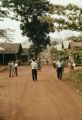 Fiji, people walking through street in rural village