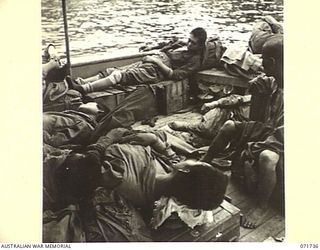 WASU, PAPUA, 1944-03-25. ELEVEN JAPANESE PRISONERS OF WAR BEING TRANSPORTED FROM WASU AND SINGORKAI TO KILIGIA BY AN AUSTRALIAN ARMY WATER TRANSPORT BOAT. ALTHOUGH THEY APPEAR IN AN ADVANCED STATE ..