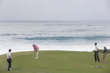 Barack Obama plays golf with Prime Minister Najib Razak, Joe Paulsen, and Mike Brush in Kaneohe Bay, Hawaii, December 24, 2014
