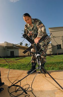 US Air Force (USAF) STAFF Sergeant (SSGT) Annie Fernandez, 15th Communications Squadron (CS) sets up a PSC-5 SATCOM Antenna, during an exercise at Hickam Air Force Base (ABF), Hawaii (HI)