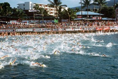 The 1,246 participants in the 1989 Ironman Triathlon take to the water at the start of the 2.4-mile swim, the first event of the triathlon, which also features a 112-mile bicycle ride and a 26.2-mile marathon run. Among the participants were eight members of the U.S. Air Force