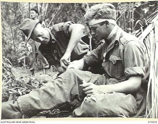 1943-10-06. NEW GUINEA. ATTACK ON LAE. THIS PLATOON OF A FAMOUS AUSTRALIAN BATTALION TOOK PART IN THE VICTORIOUS ADVANCE ON LAE. J. STEWART OF GLADESVILLE, N.S.W. ONE OF THE AIDE POST STRETCHER ..
