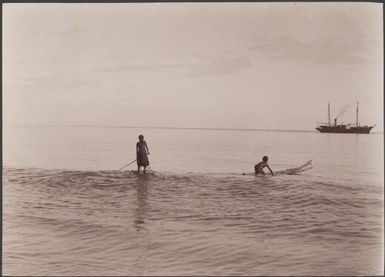 Two boys on surfboards at Guadalcanar and the Southern Cross in background, Solomon Islands, 1906 / J.W. Beattie