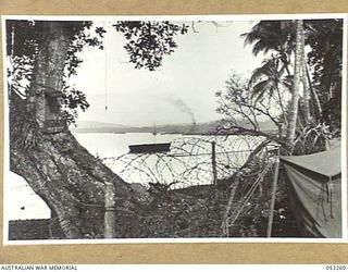 MILNE BAY, NEW GUINEA. 1943-06-29. MILNE BAY EARLY IN THE MORNING, LOOKING FROM LYAL WHARF TOWARDS PONTOON WHARF