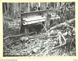 DUMPU AREA, NEW GUINEA. 1944-04-18. SAPPER COOK, 53RD FIELD PARK COMPANY OPERATING A BULLDOZER TO ASSIST CONSTRUCTION OF THE ROAD BY THE 15TH FIELD COMPANY, ROYAL AUSTRALIAN ENGINEERS
