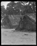 Portrait of man, in front of canoe houses