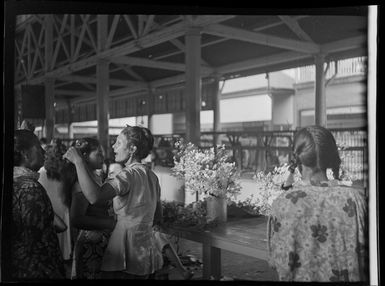 Market scene with woman selling flowers, Papeete, Tahiti