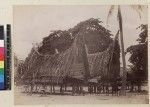 Woman and children outside village houses, Wari Island, Papua New Guinea, ca. 1890