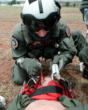 Hospital Corpsman Third Class (HM3) Raymond Munn, Helicopter Combat Support Squadron Five (HCSS5), from Cheyenne, Wyoming, works Oscar the trauma victim during an overland Search And Rescue (SAR) training exercise