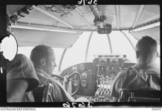 Flying Officers 260275 Godfrey Ellard Hemsworth, and 147 Keith Macdermott Hampshire, both of No 11 Squadron, RAAF, shown flying between Cairns and Port Moresby. Flg Off Hemsworth went missing ..