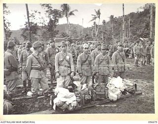 KAIRIRU ISLAND, NEW GUINEA. 1945-09-17. JAPANESE MEDICAL PERSONNEL ASSEMBLED WITH ALL THEIR GEAR AT THE BEACH HEAD ON THE ISLAND WAITING TO BOARD BARGES FOR TRANSFER TO MUSCHU ISLAND. FOLLOWING THE ..