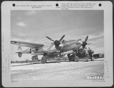 Ground Crew Personnel Load Wing Tank On The Lockheed P-38 'Little Red Head', Isley Field, Saipan, Marianas Islands, November 1944. (U.S. Air Force Number 64462AC)