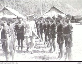 TOROKINA, BOUGAINVILLE, 1945-12-04. MAJOR-GENERAL W. BRIDGEFORD, GENERAL OFFICER IN CHARGE 3 DIVISION, INSPECTING THE GUARD OF HONOUR FORMED BY MEMBERS OF THE ROYAL PAPUAN CONSTABULARY AT A MEDAL ..