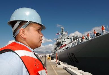 A U.S. Navy Sailor prepares to perform line handlers duty for the Chinese Peoples Liberation Army Navy Luhu (Type 052) Class Guided Missile Destroyer QINGDAO (DDG 113) as the ship departs Naval Station Pearl Harbor, Hawaii, on Sept. 10, 2006 after a Goodwill Visit. The visit provides an excellent opportunity to enhance cooperation between the two navies and underscores the United States commitment to supporting ongoing cooperative efforts in the Pacific Region. (U.S. Navy photo by Mass Communication SPECIALIST 1ST Class James E. Foehl) (Released)