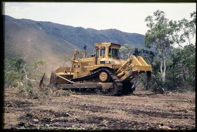 Bulldozer clearing maquis