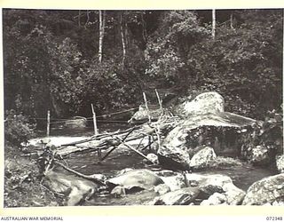 TEMPLETON'S CROSSING, NEW GUINEA. 1944-04-09. THE FOOT BRIDGE AT THE TEMPLETON'S CROSSING SIGNAL STATION. THE SIGNAL STATION IS OPERATED BY THE 23RD LINE SECTION, 18TH LINES OF COMMUNICATION ..